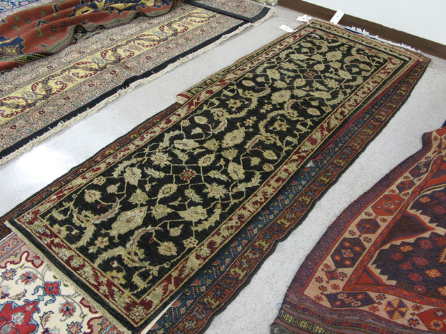 Appraisal: PAKISTANI PERSIAN RUNNER overall floral decoration on black ground '