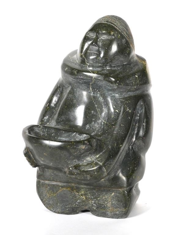 Appraisal: Large Inuit Eskimo figure holding bowl Soapstone has a polished