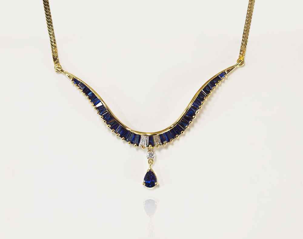 Appraisal: K SAPPHIRE AND DIAMOND NECKLACE K yellow gold necklace contains