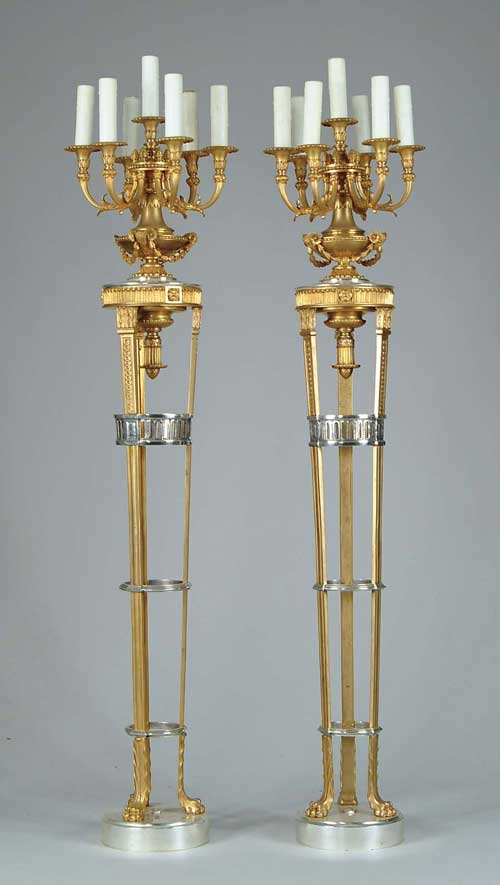 Appraisal: OUTSTANDING PAIR OF BRONZE AND SILVER TORCHERES The floor candelabra