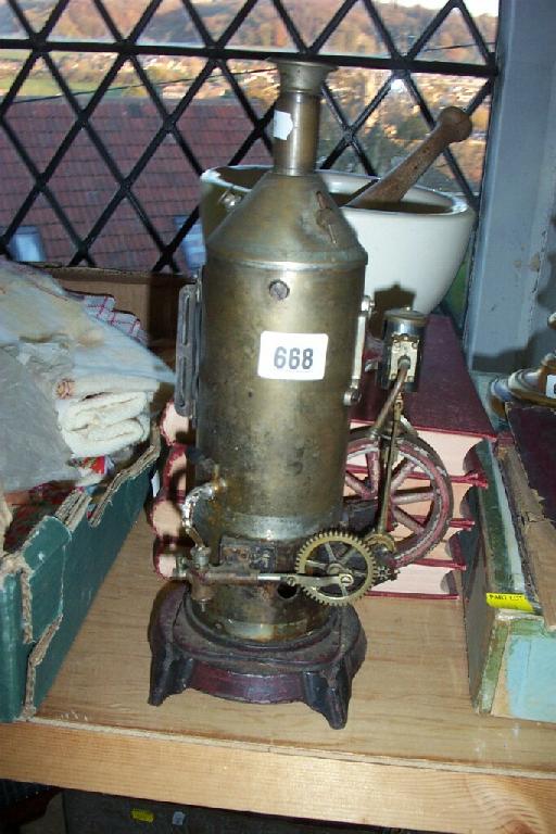 Appraisal: A brass stationary steam engine together with a pestle and