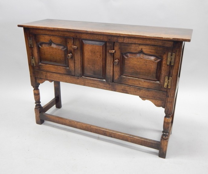 Appraisal: A reproduction oak dresser in the manner of Titchmarsh and