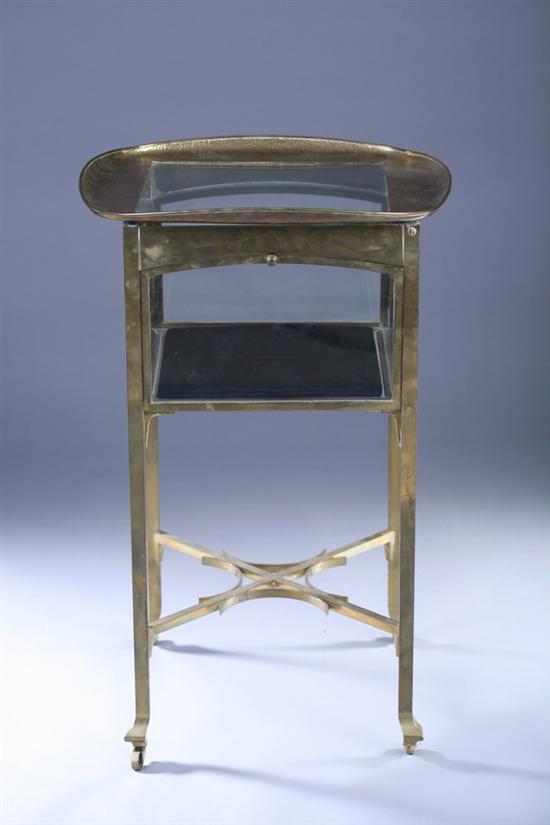 Appraisal: CONTEMPORARY HAMMERED BRASS AND GLASS VITRINE TABLE th century Rounded-corner