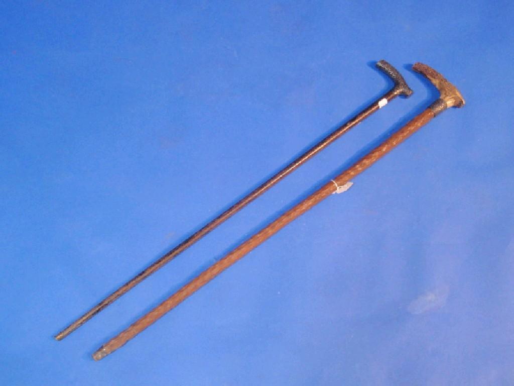 Appraisal: A silver handled walking stick the handle embossed with scrolls