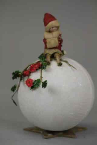 Appraisal: LARGE GIRL ON SNOWBALL CANDY CONTAINER Germany bisque head spun