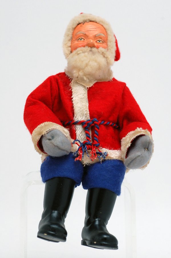 Appraisal: Seated German Santa with painted composition face felt outfit lambs