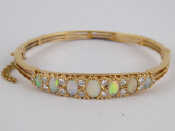 Appraisal: A carat gold opal and diamond bangle largest opal approx