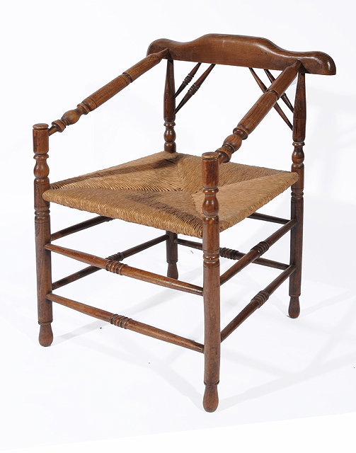 Appraisal: AN EARLY TH CENTURY ELM ARMCHAIR with rush seat and