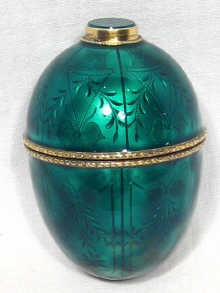 Appraisal: An enamelled silver gilt egg the bright cut decoration covered