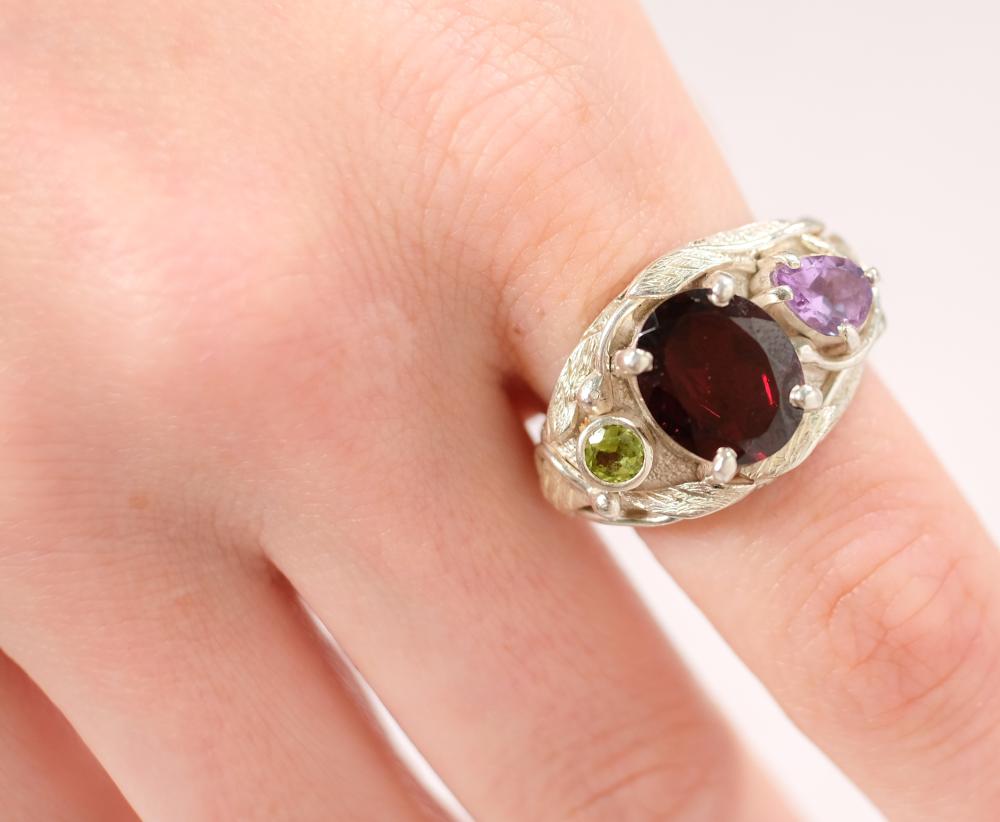 Appraisal: Sterling silver ring set with oval x mm Garnet and