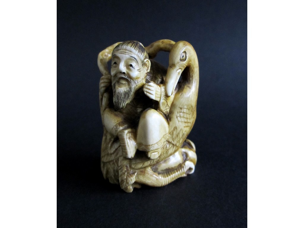 Appraisal: A Japanese carved ivory netsuke of a sage seated on