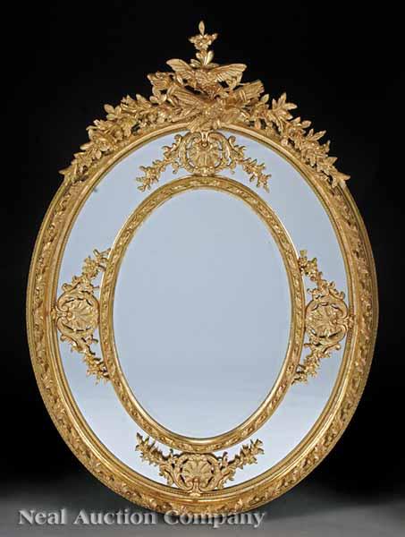 Appraisal: A Monumental Napoleon III-Style Carved and Gilded Oval Mirror the