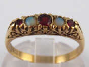 Appraisal: A carat gold garnet and opal ring circa ring size