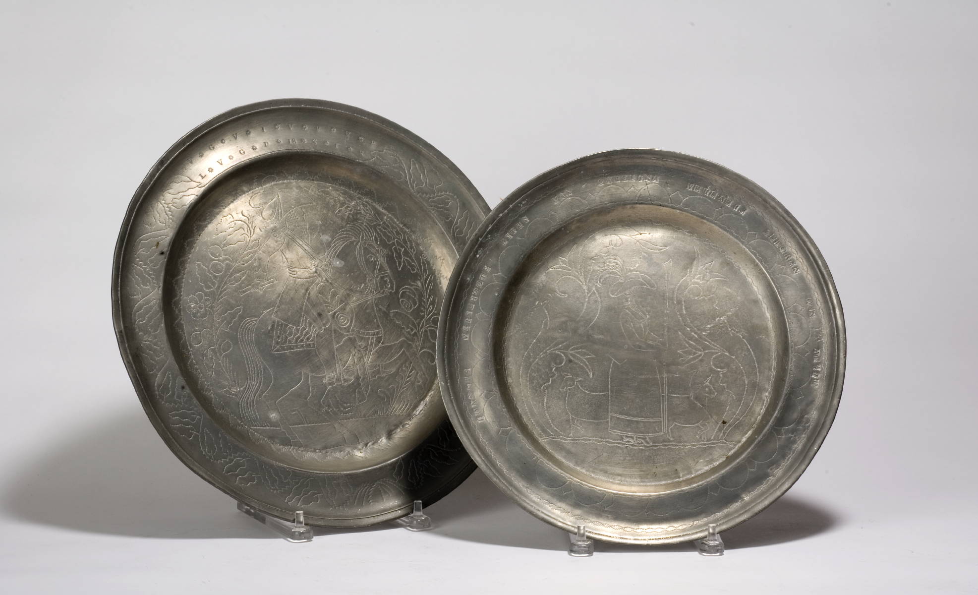 Appraisal: TWO PEWTER CHARGERS WITH WRIGGLE-WORK DECORATION Diameter of largest inches