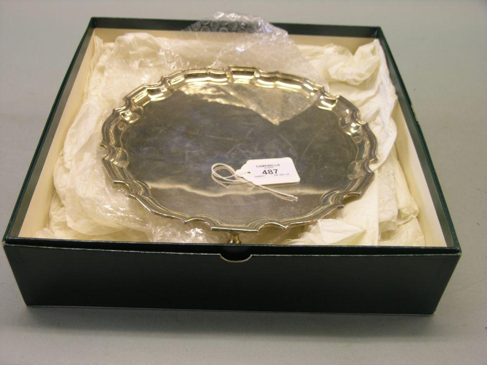 Appraisal: A silver salver with piecrust rim on knurled scroll feet