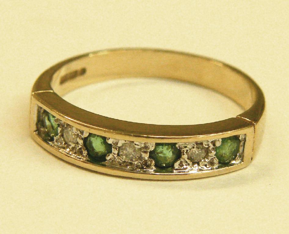 Appraisal: Emerald and diamond ct half eternity ring