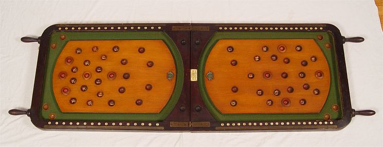 Appraisal: TH C BAGATELLE TABLE Utilt Company label Hinged mahogany case