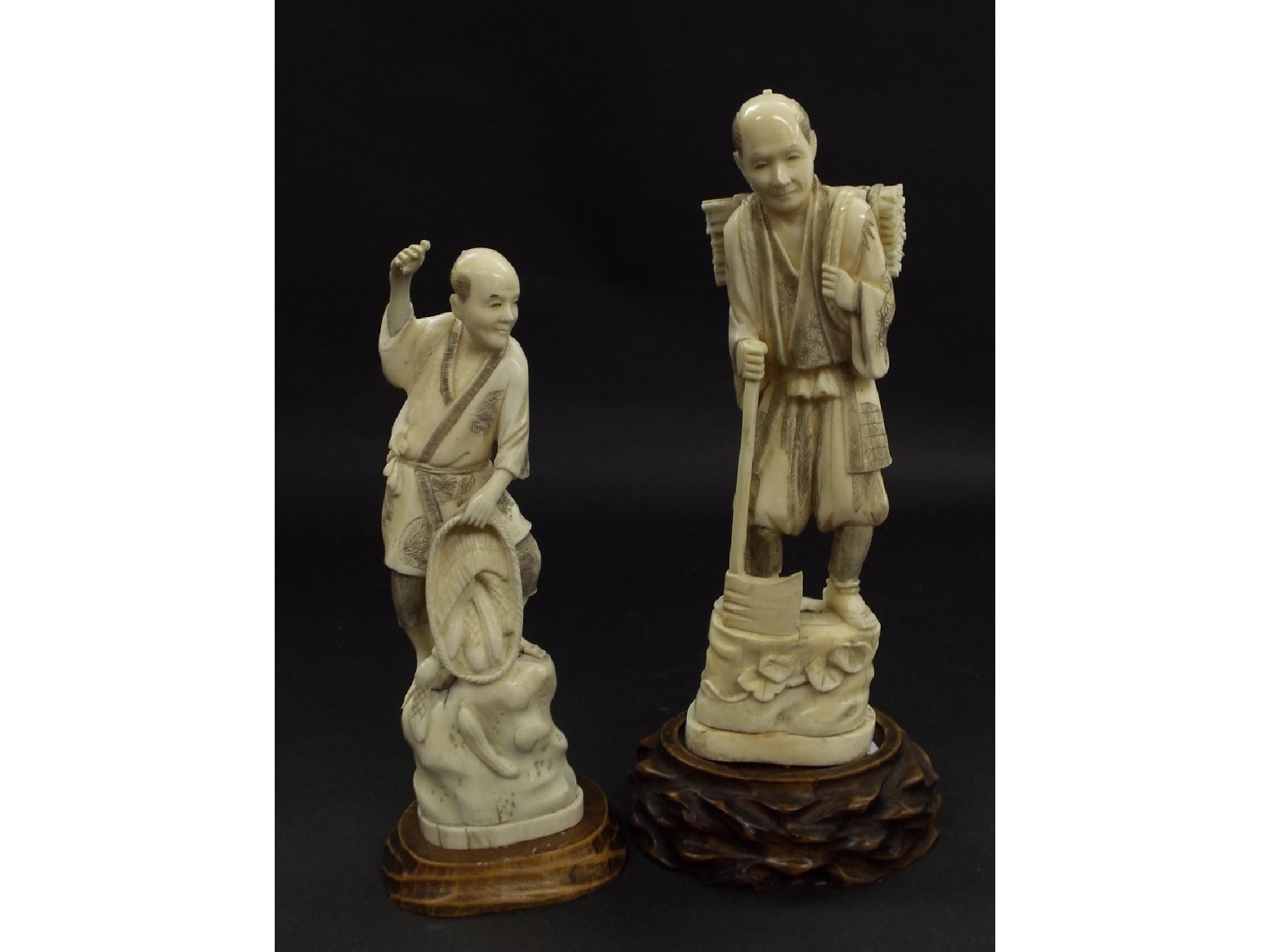 Appraisal: Two similar Japanese carved ivory okimono figures each of standing