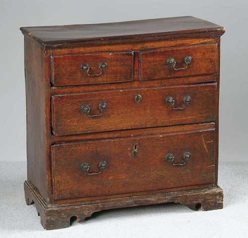 Appraisal: MINIATURE ENGLISH WALNUT CHIPPENDALE CHEST Two over two drawers Each