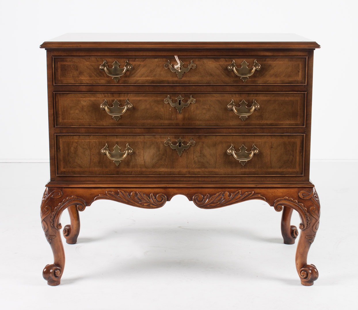 Appraisal: Baker Georgian style banded walnut chest from the Stately Homes