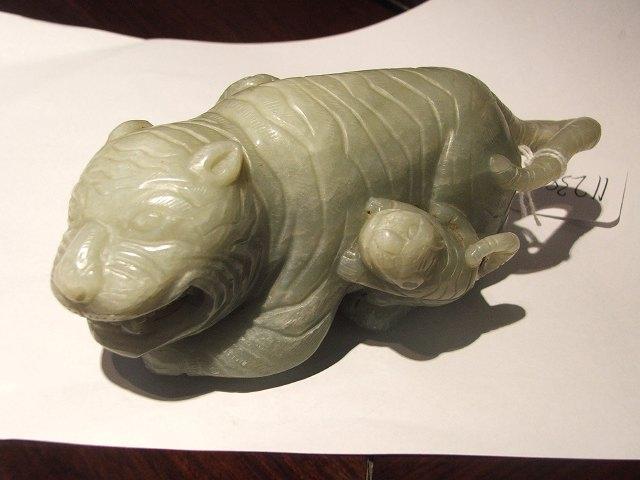 Appraisal: A CHINESE CARVED JADE MODEL of a tiger with cubs