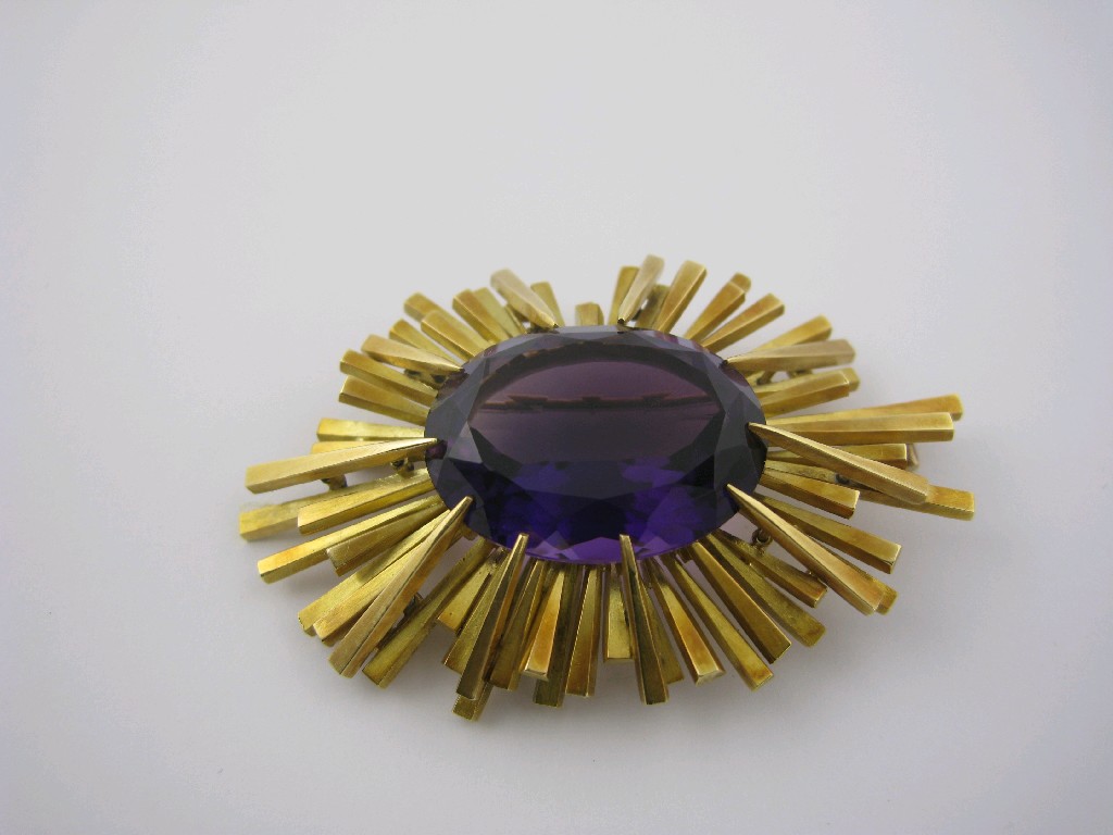 Appraisal: An Amethyst Starburst Brooch the large oval-cut stone claw-set in