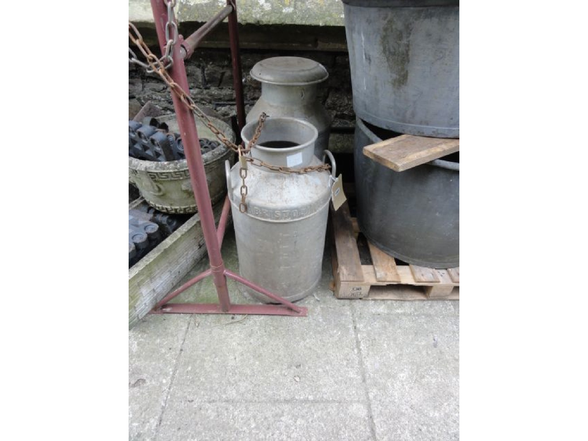 Appraisal: Two aluminium milk churns one complete with cap and raised