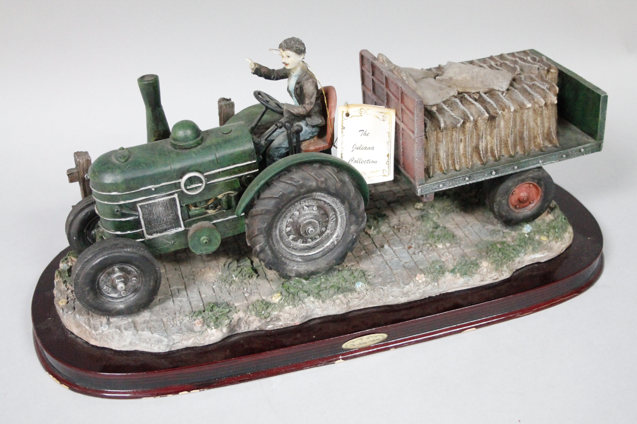 Appraisal: A thC Juliana resin sculpture of farmer on green tractor