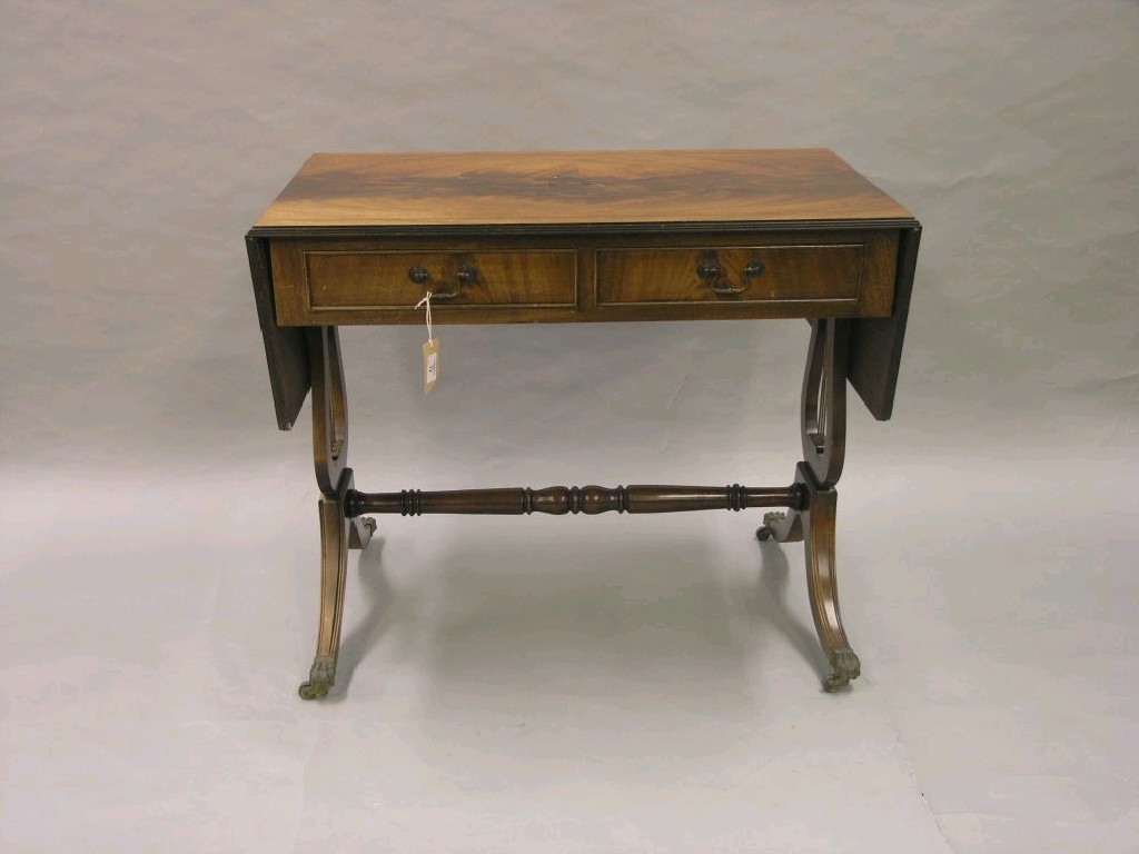 Appraisal: A reproduction mahogany sofa table with two frieze drawers on