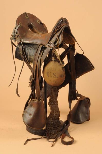 Appraisal: WWI Period McClellan Saddle Includes stirrups canteen and rifle scabbard