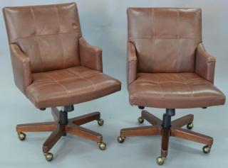 Appraisal: Pair of Councill leather armchairs having swivel bases Pair of