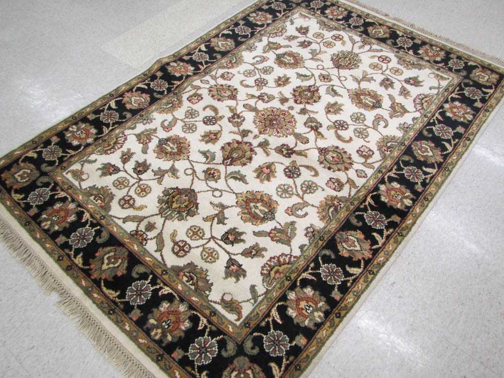 Appraisal: HAND KNOTTED ORIENTAL CARPET Indo-Persian overall floral design on cream