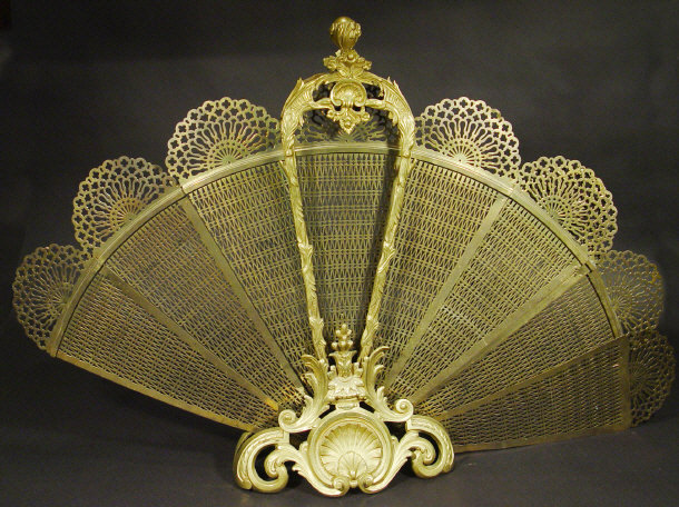 Appraisal: Large brass fan shaped spark guard with floral and shell