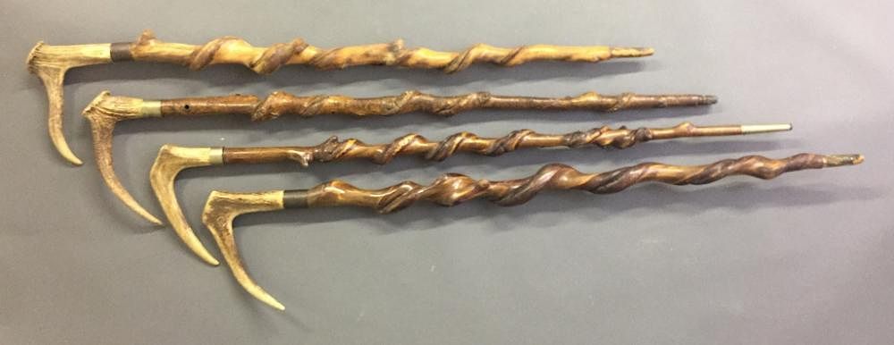 Appraisal: Four Similar Stag Handled Walking Sticks Four similar stag handled