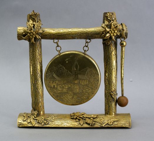 Appraisal: A brass bell with gong The frame modelled as bark