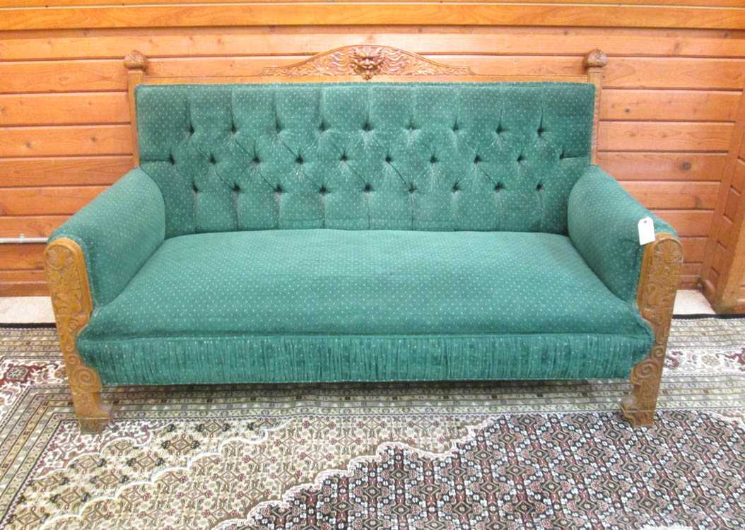 Appraisal: CARVED OAK AND GREEN UPHOLSTERED SOFA American c H x