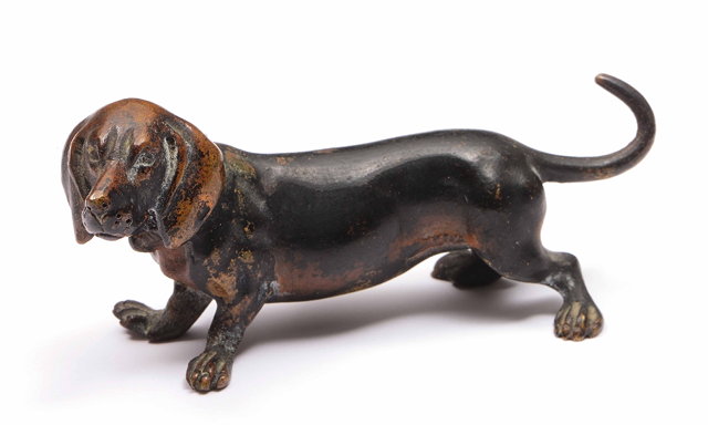 Appraisal: An Austrian bronze model of a sausage dogwith cold painted