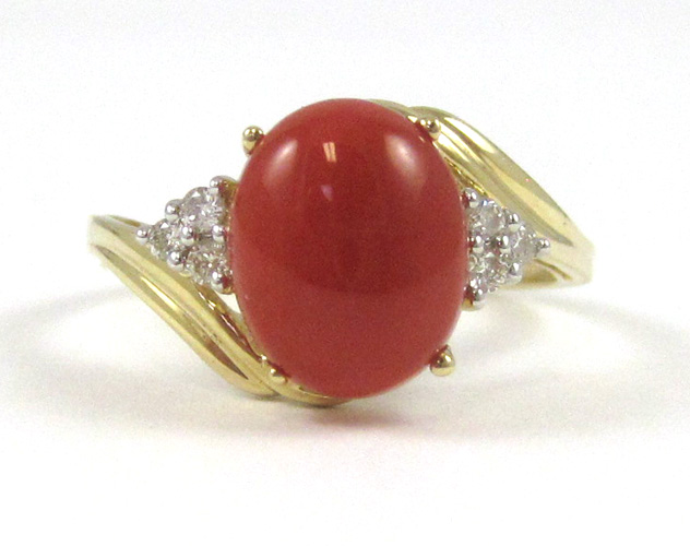 Appraisal: CORAL DIAMOND AND FOURTEEN KARAT GOLD RING with three round-cut