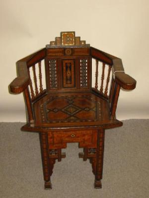 Appraisal: A MIDDLE EASTERN HARDWOOD AND EBONY ELBOW CHAIR C of