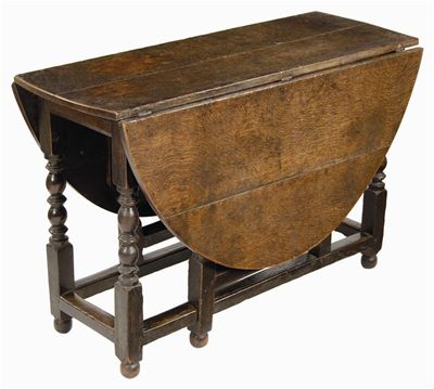 Appraisal: An oak gateleg table the oval drop-leaf top on block