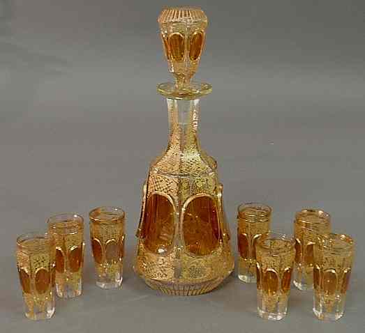 Appraisal: Amber cut glass decanter and seven glasses with gilt decoration