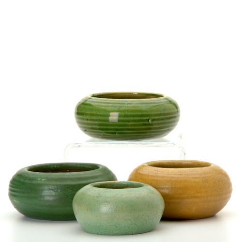 Appraisal: GRUEBY Four small low bowls in greens or ochre Hairlines