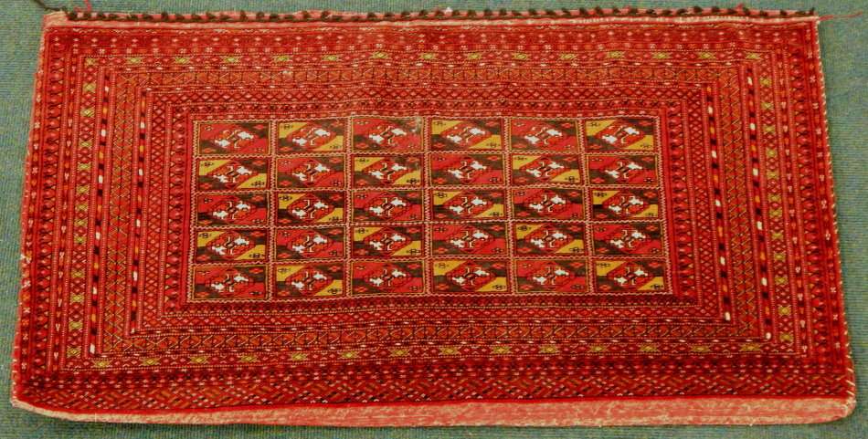 Appraisal: A Turkomen rug in repeat geometric pattern predominately in red