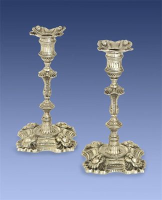 Appraisal: A pair of cast George II candlesticks with knopped and