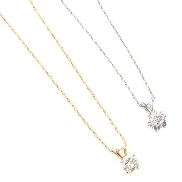 Appraisal: A collection of diamond and gold solitaire pendants with gold