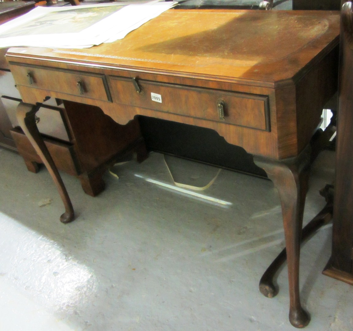 Appraisal: A th century walnut two drawer writing desk on ball