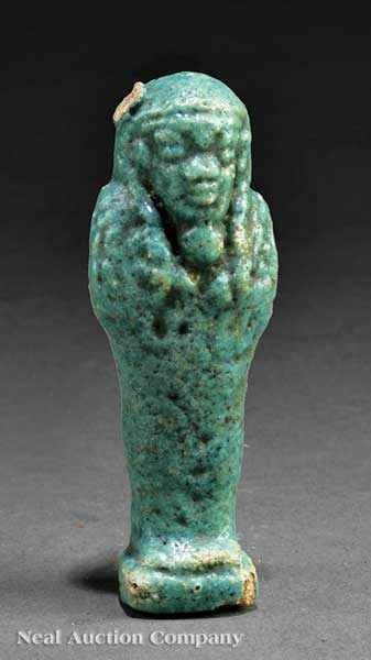 Appraisal: An Egyptian Fa ence Shabti the figure modeled standing on