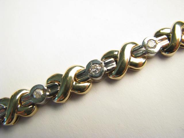 Appraisal: An K white and yellow gold Hugs and Kisses Bracelet