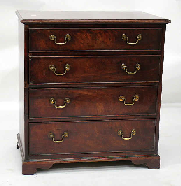 Appraisal: A SMALL MAHOGANY CHEST OF FOUR LONG DRAWERS and standing