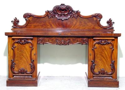 Appraisal: A VICTORIAN MAHOGANY PEDESTAL SIDEBOARD the raised scroll edged back